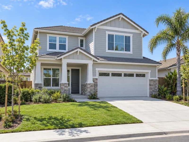 Modern suburban two-story home with a lawn and two-car garage